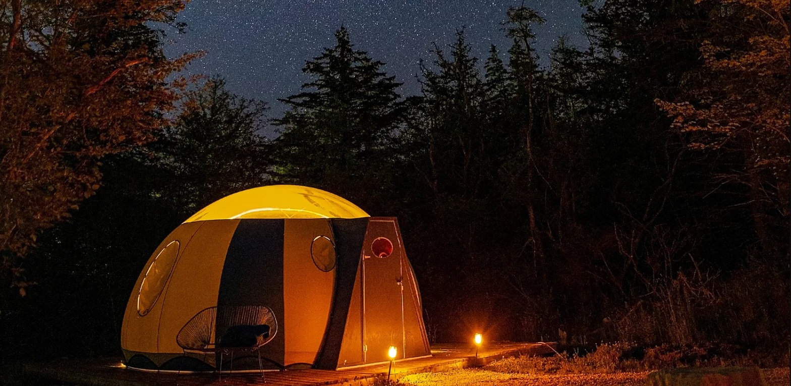 Night photo of the Sky-bubbly tents available to rent in Yarmouth County that have glass tops 