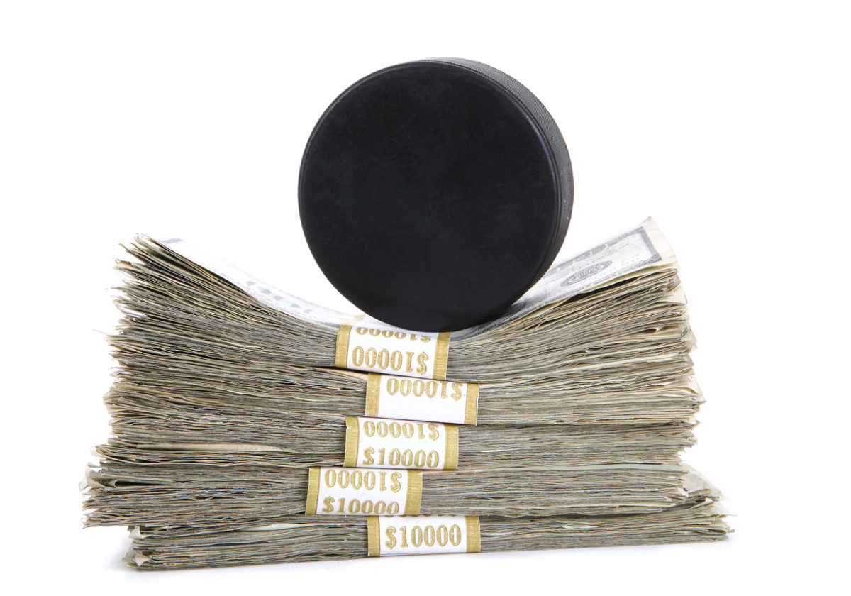 a hockey puck with piles of money